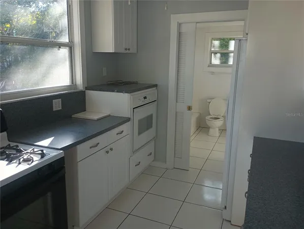 a kitchen with stainless steel appliances a sink stove and cabinets