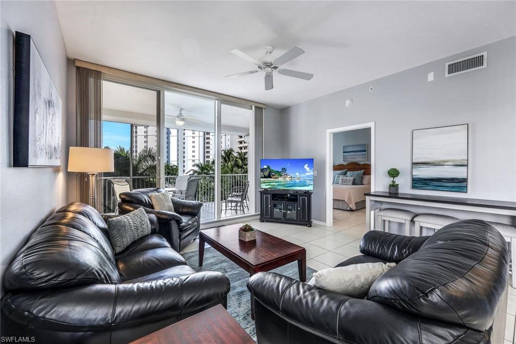 460 Launch Circle, Unit 401 Naples, FL 34108 - Photo 3 of 24 a living room with furniture and a fireplace