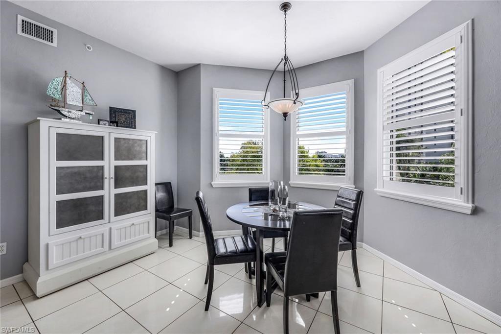 460 Launch Circle, Unit 401 Naples, FL 34108 - Photo 6 of 24 a view of a dining room with furniture window and outside view