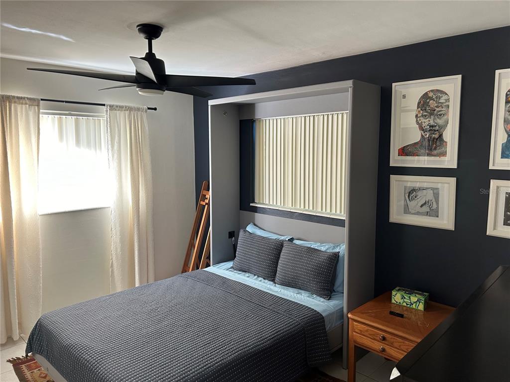 10172 63rd Avenue North Seminole, FL 33772 - Photo 13 of 24 a bedroom with a bed and wooden floor