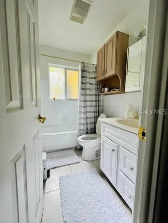 a bedroom with a bed and a tv