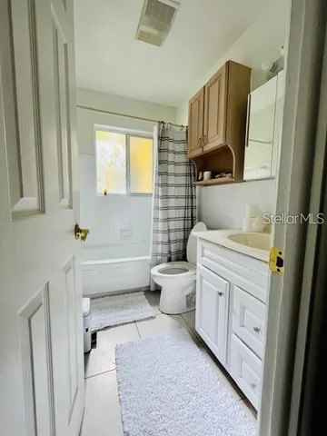 a bedroom with a bed and a tv