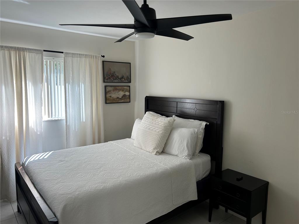 10172 63rd Avenue North Seminole, FL 33772 - Photo 19 of 24 a bedroom with a bed and a tv