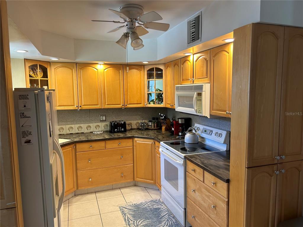 10172 63rd Avenue North Seminole, FL 33772 - Photo 6 of 24 a kitchen with stainless steel appliances granite countertop a sink stove and refrigerator