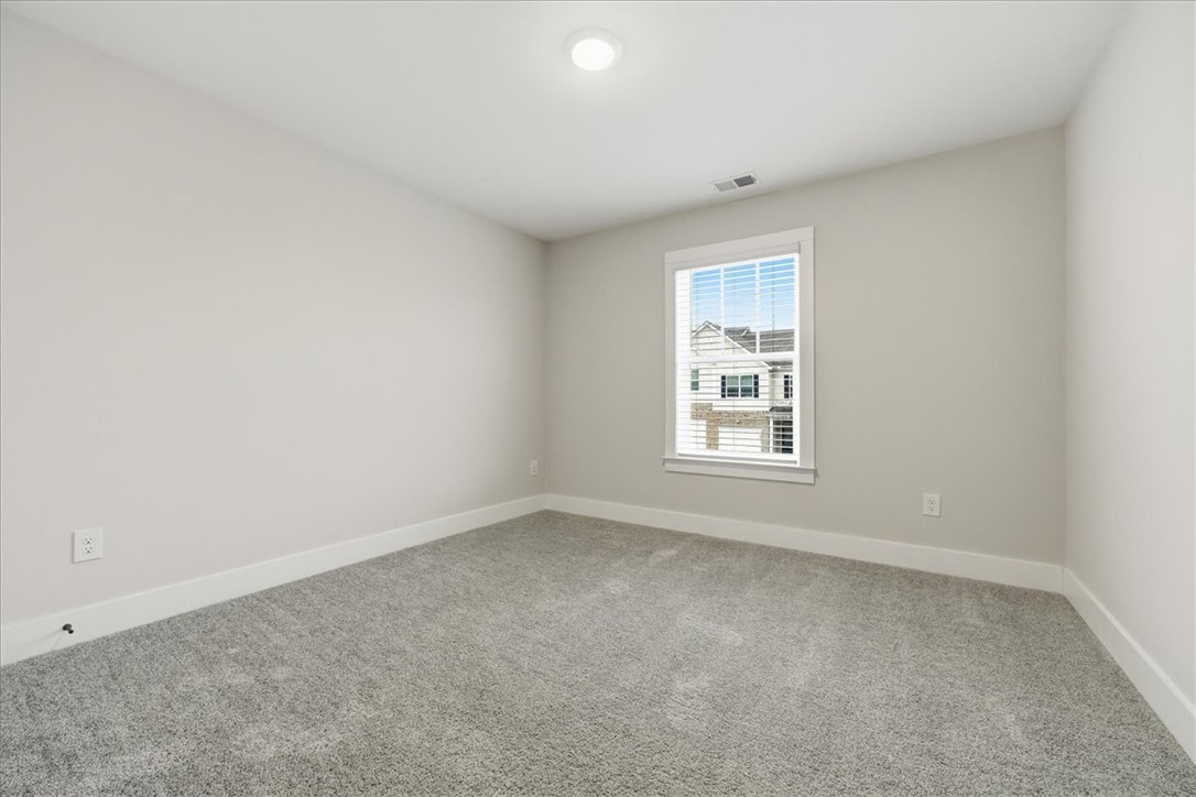 427 Bee Cv Way Pendleton, SC 29670 - Photo 18 of 32 A well-lit bedroom features plush carpeting and a bright window offering neighborhood views.