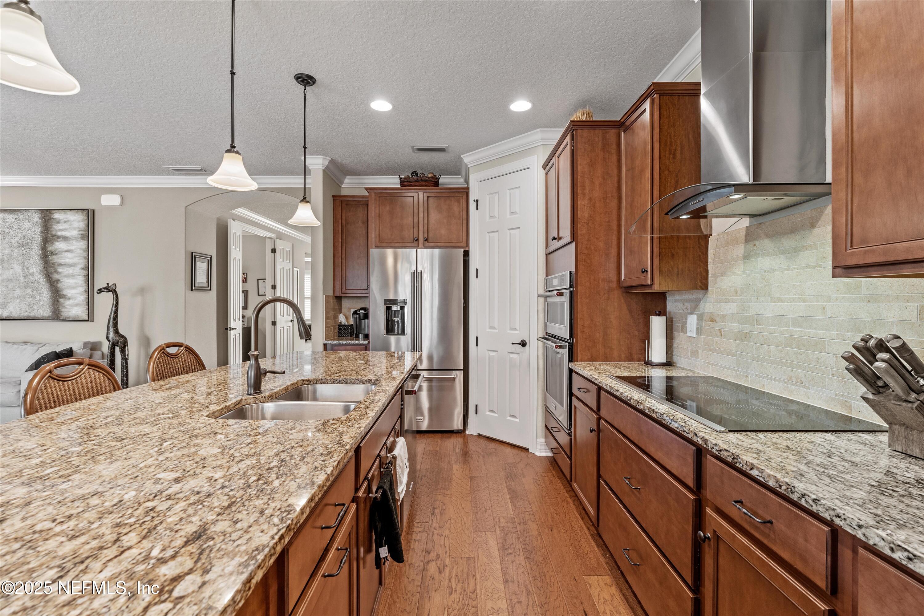 440 Winding Path Drive Ponte Vedra, FL 32081 - Photo 15 of 35 a kitchen with stainless steel appliances granite countertop a sink refrigerator and cabinets