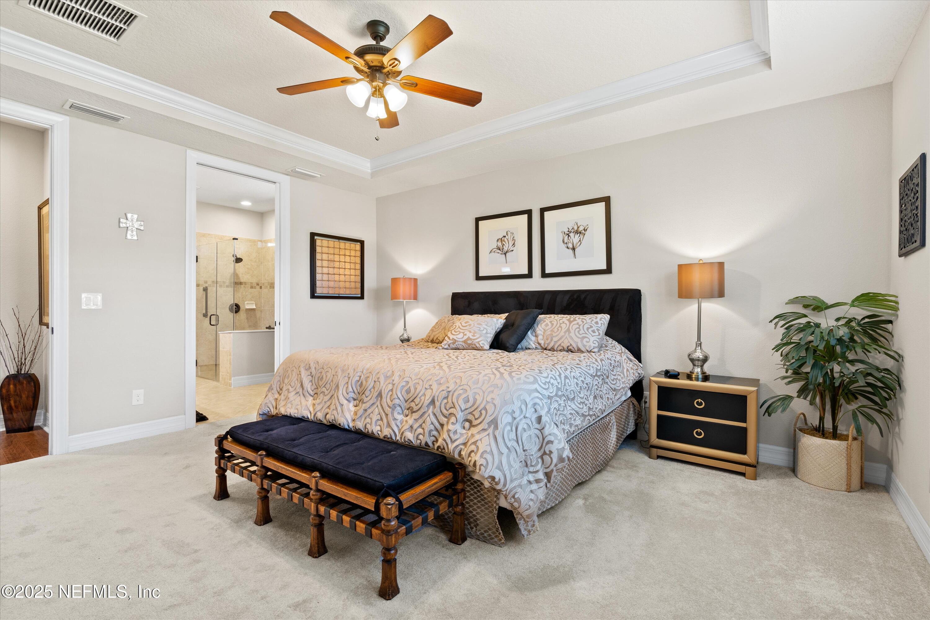 440 Winding Path Drive Ponte Vedra, FL 32081 - Photo 21 of 35 a bedroom with a bed and a chandelier