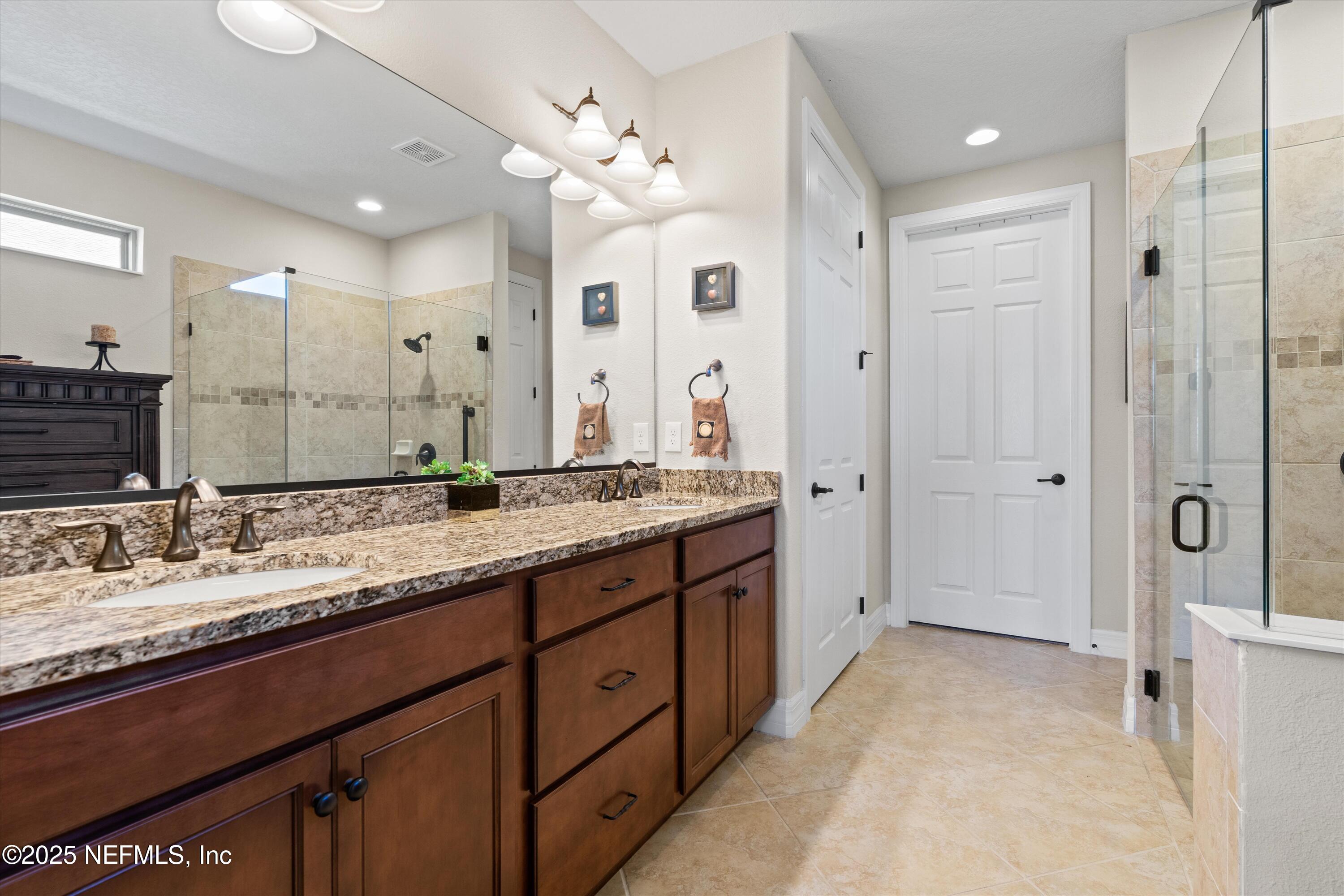 440 Winding Path Drive Ponte Vedra, FL 32081 - Photo 23 of 35 a spacious bathroom with a granite countertop sink mirror and shower