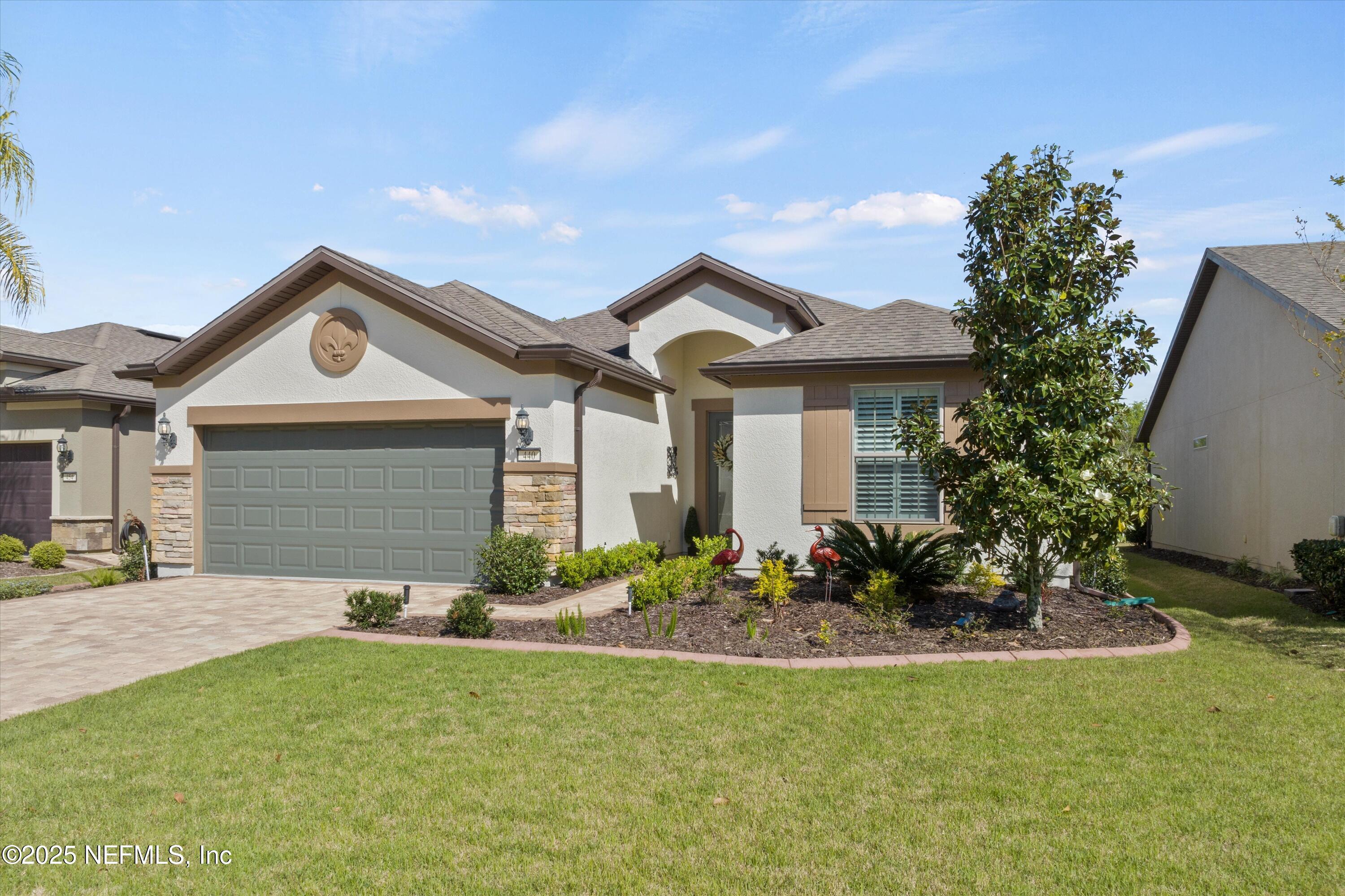 440 Winding Path Drive Ponte Vedra, FL 32081 - Photo 30 of 35 a front view of a house with a garden and yard