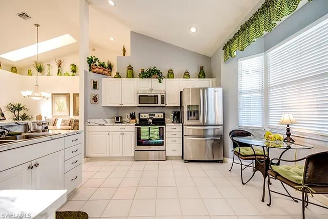 a kitchen with a sink appliances and cabinets