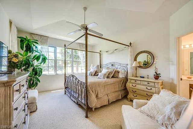 a bedroom with furniture and a large window