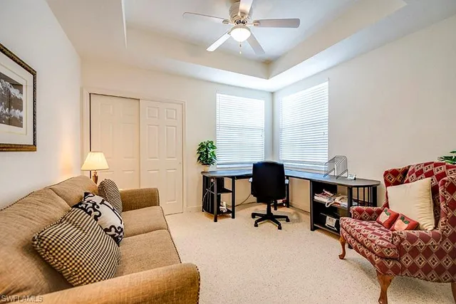 a living room with furniture and a work place
