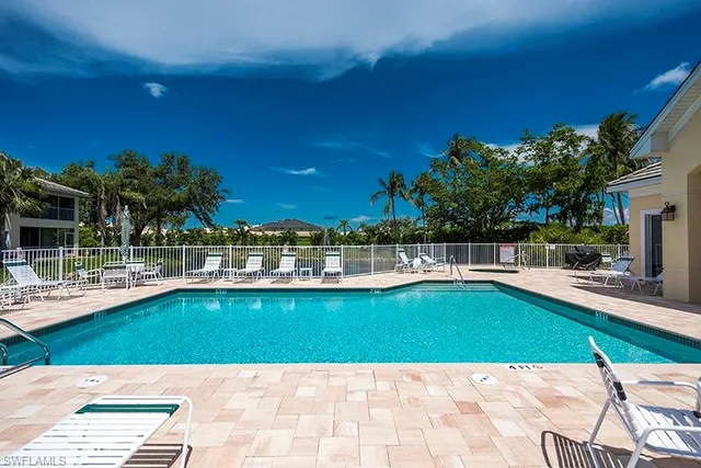 a view of swimming pool with a lounge chairs