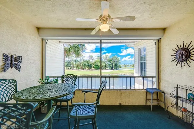 a balcony with table and chairs