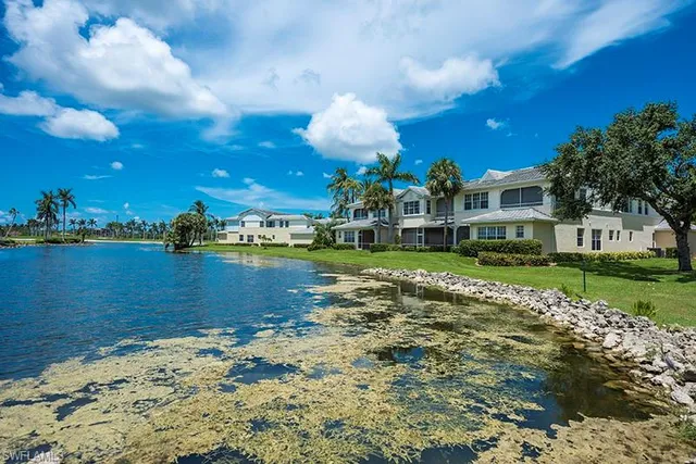 a view of a lake with a house in the background