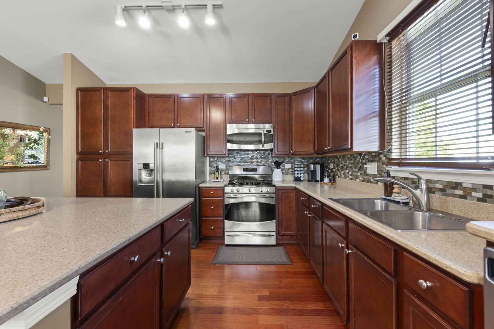 929 Fairmont Road Pingree Grove, IL 60140 - Photo 12 of 28 a kitchen with stainless steel appliances granite countertop a sink stove and refrigerator