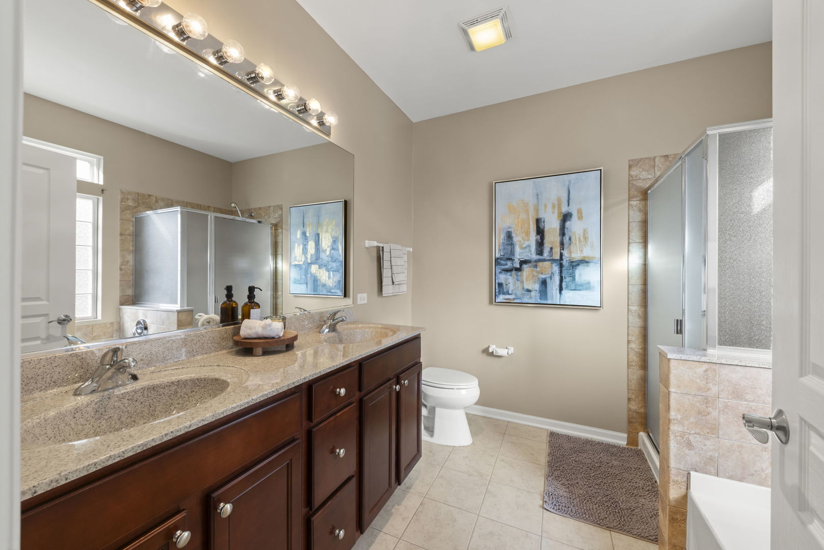 929 Fairmont Road Pingree Grove, IL 60140 - Photo 20 of 28 a bathroom with a granite countertop double vanity sink a toilet and a mirror