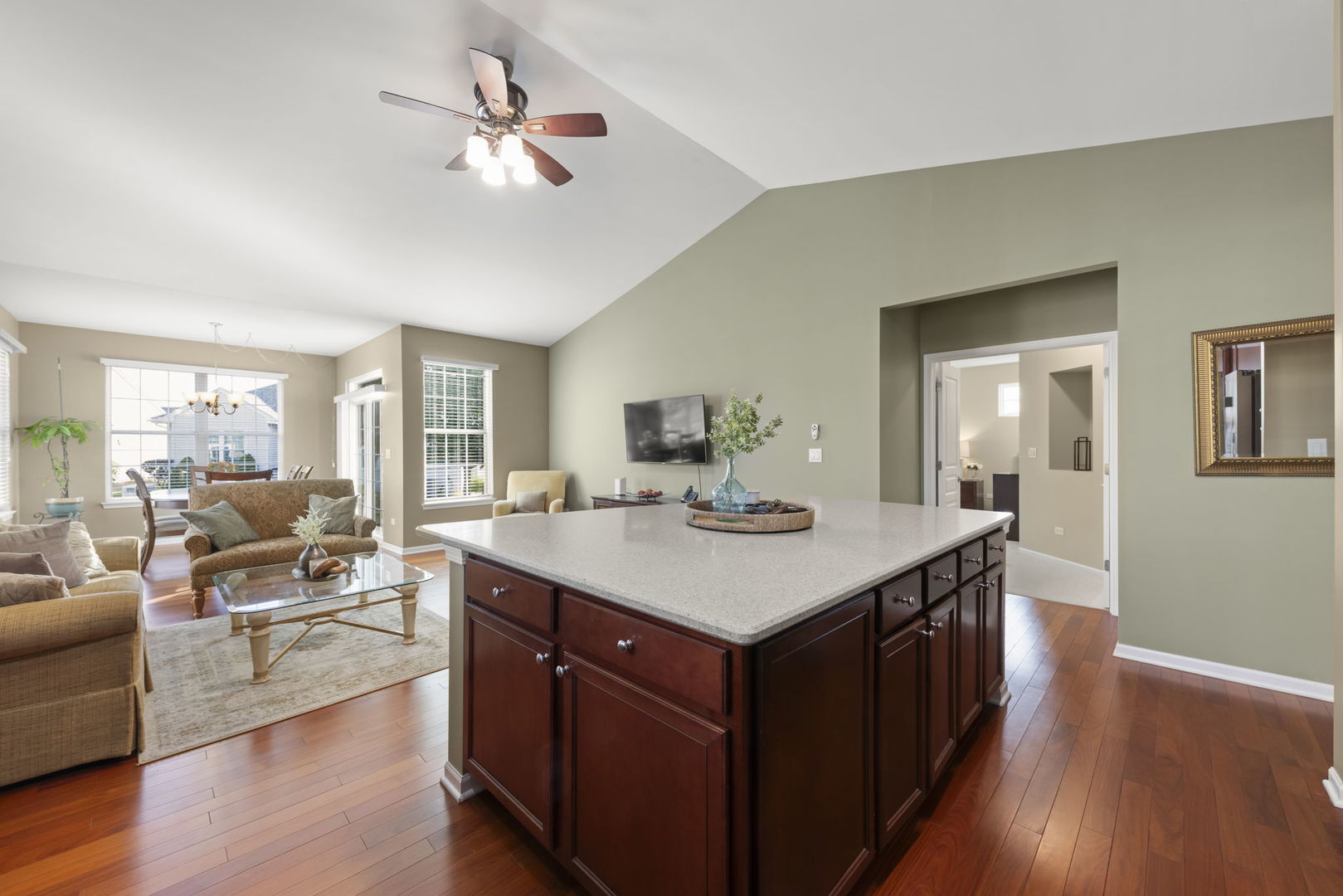 929 Fairmont Road Pingree Grove, IL 60140 - Photo 10 of 28 a living room with stainless steel appliances kitchen island a table chairs in it and wooden floors