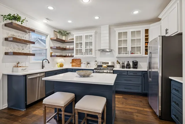 a kitchen with stainless steel appliances granite countertop a stove and a sink