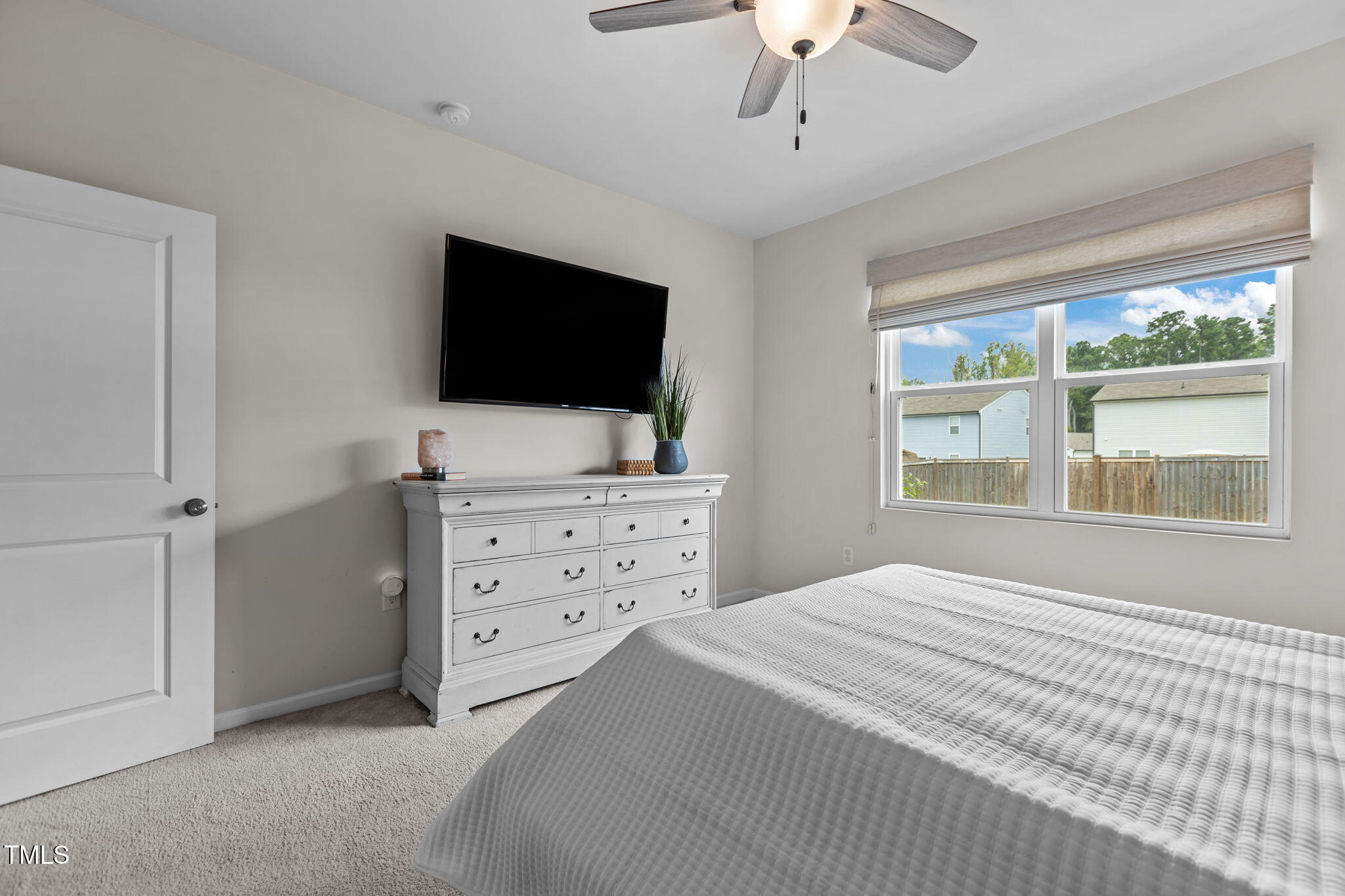 3521 Strawberry Patch Row Raleigh, NC 27604 - Photo 22 of 38 a bedroom with a bed and a flat screen tv