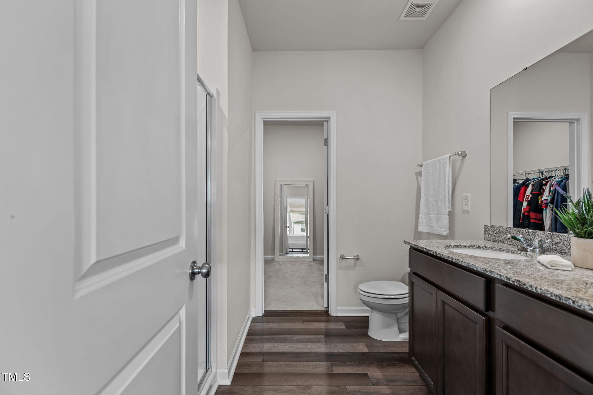 3521 Strawberry Patch Row Raleigh, NC 27604 - Photo 23 of 38 a bathroom with a granite countertop sink toilet and mirror