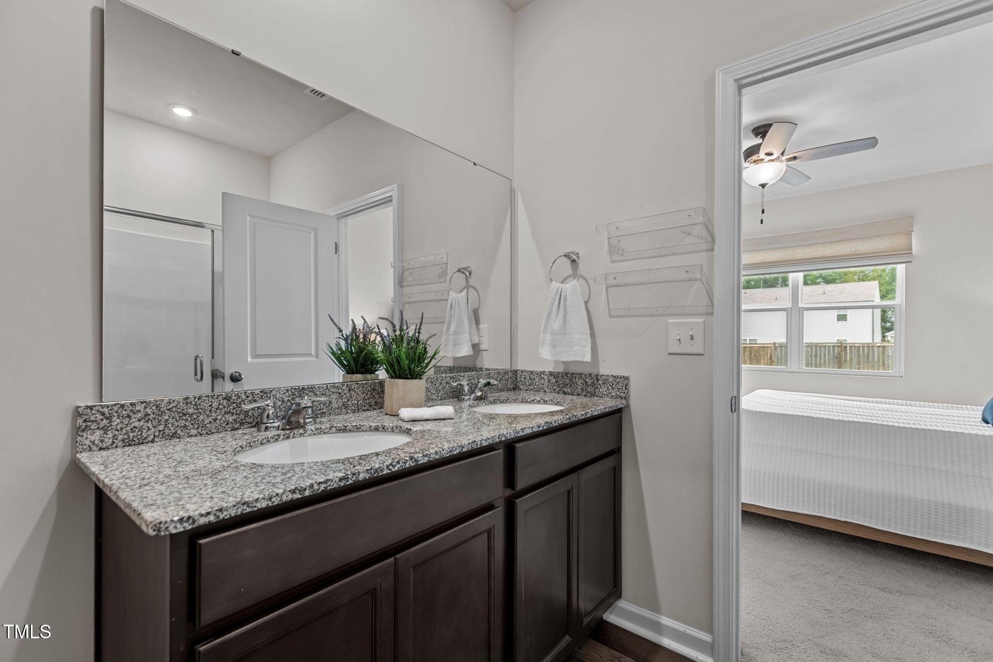 3521 Strawberry Patch Row Raleigh, NC 27604 - Photo 24 of 38 a bathroom with a granite countertop sink and a mirror