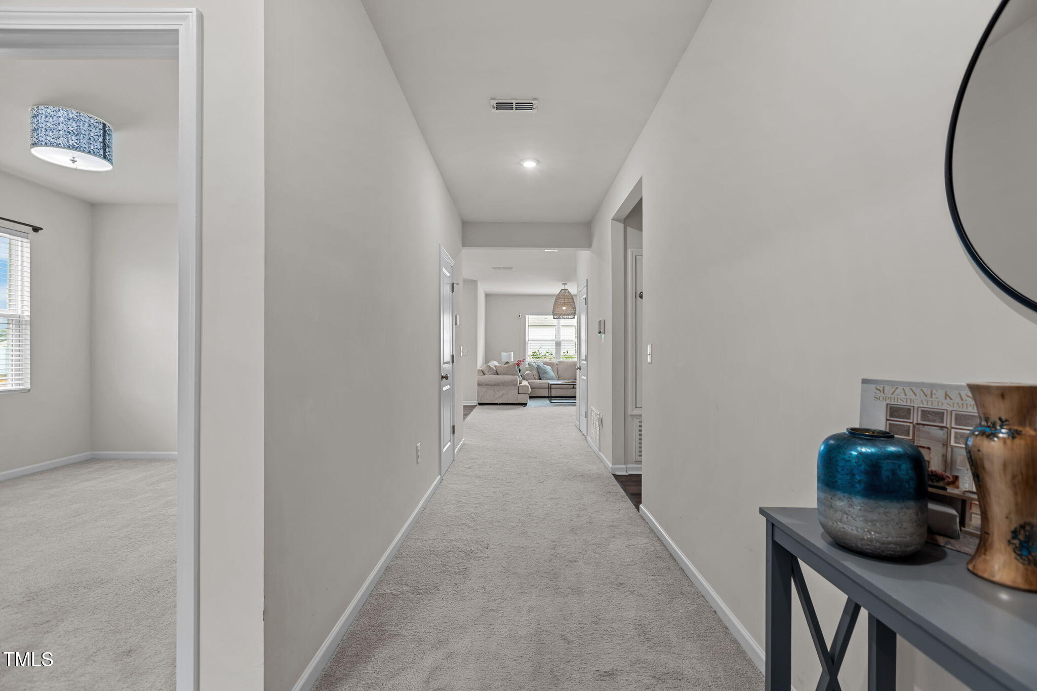 3521 Strawberry Patch Row Raleigh, NC 27604 - Photo 3 of 38 a view of a hallway to a livingroom and a livingroom with furniture