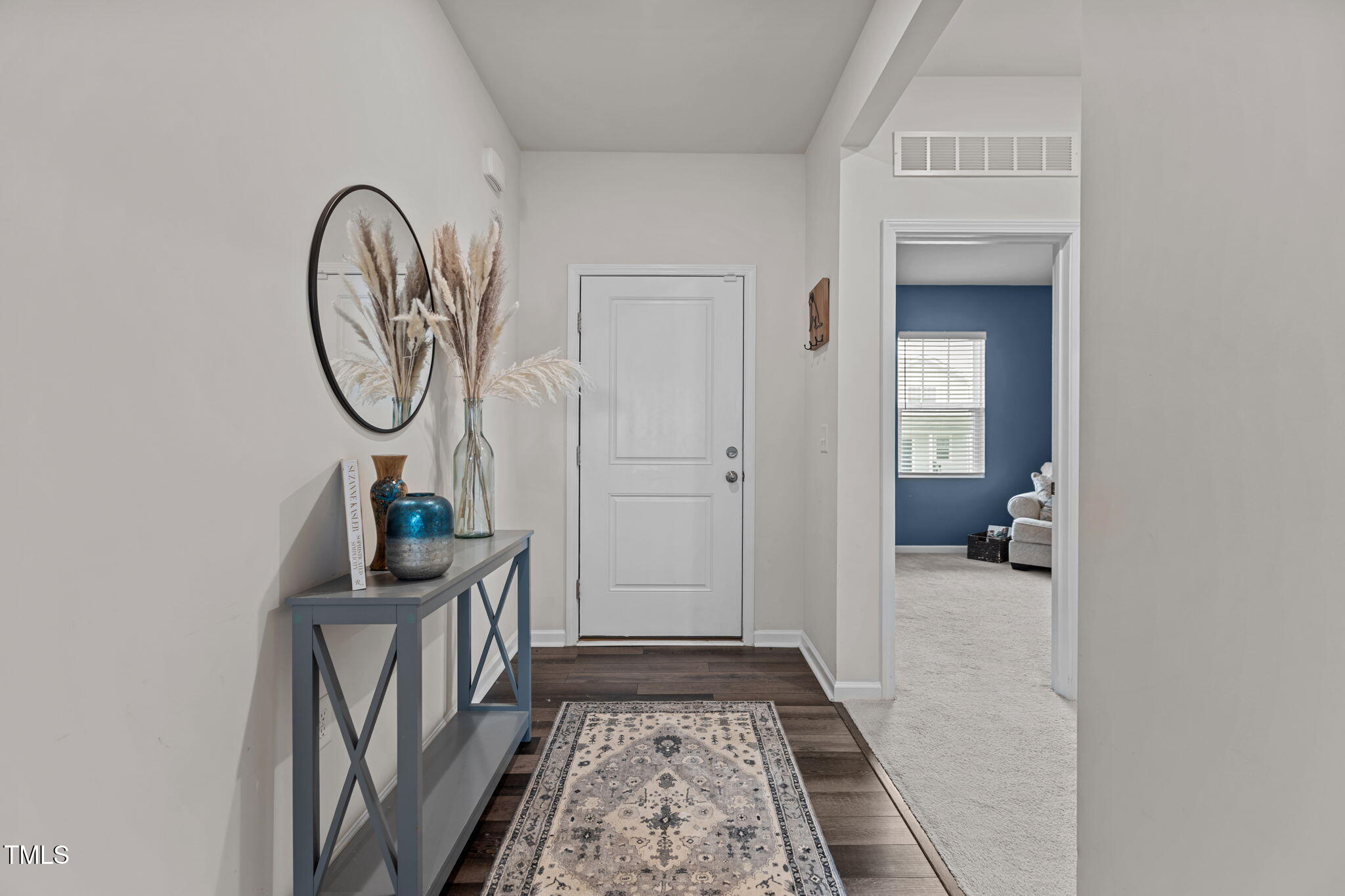 3521 Strawberry Patch Row Raleigh, NC 27604 - Photo 4 of 38 a view of a hallway with wooden floor and a entryway