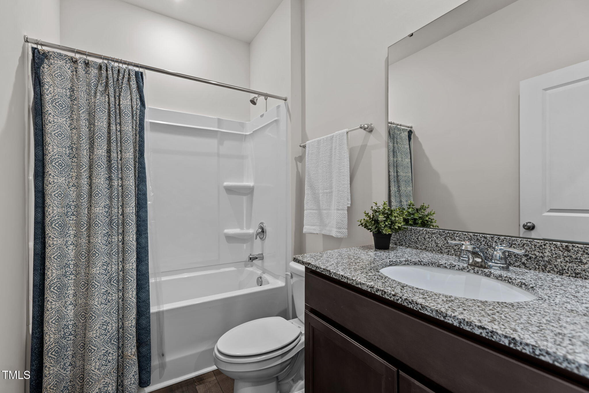 3521 Strawberry Patch Row Raleigh, NC 27604 - Photo 7 of 38 a bathroom with a granite countertop sink toilet and shower