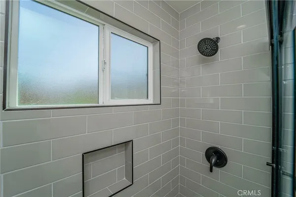 a bathroom with a shower and a window