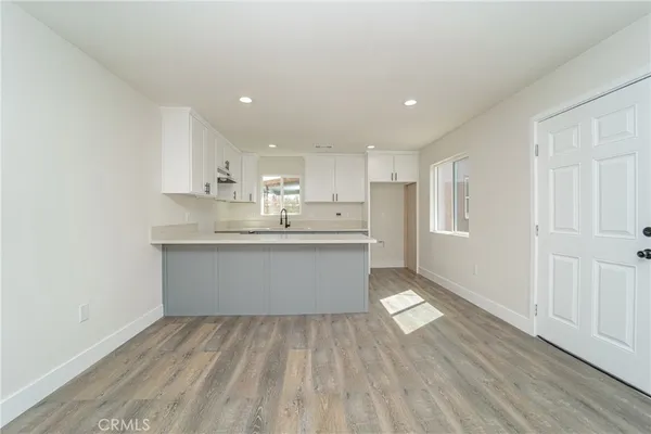 a view of kitchen with granite countertop cabinets and sink