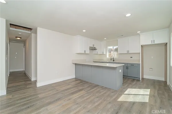 a large kitchen with a lot of counter space and stainless steel appliances
