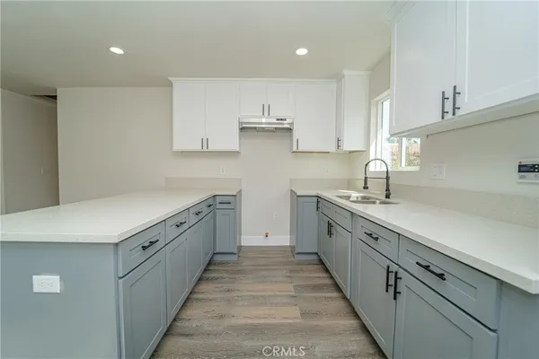 a kitchen with cabinets and window