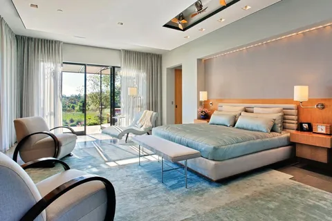 a bedroom with bed and wooden floor