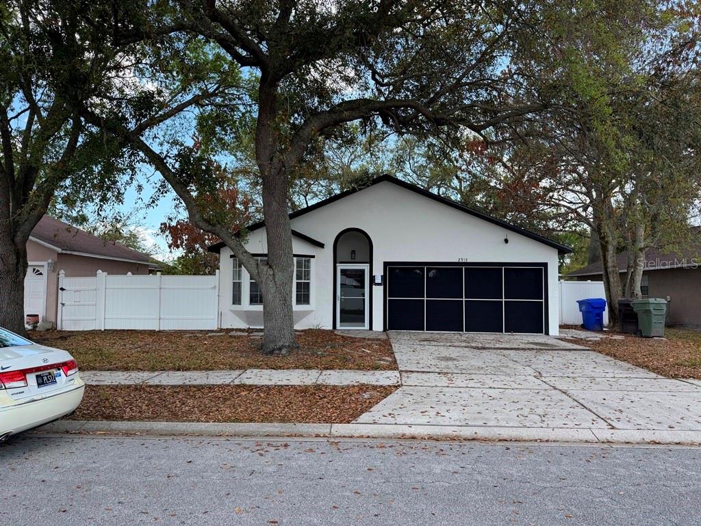 2915 Colleen Circle Kissimmee, FL 34744 - Photo 1 of 1 a front view of a house with a yard and garage