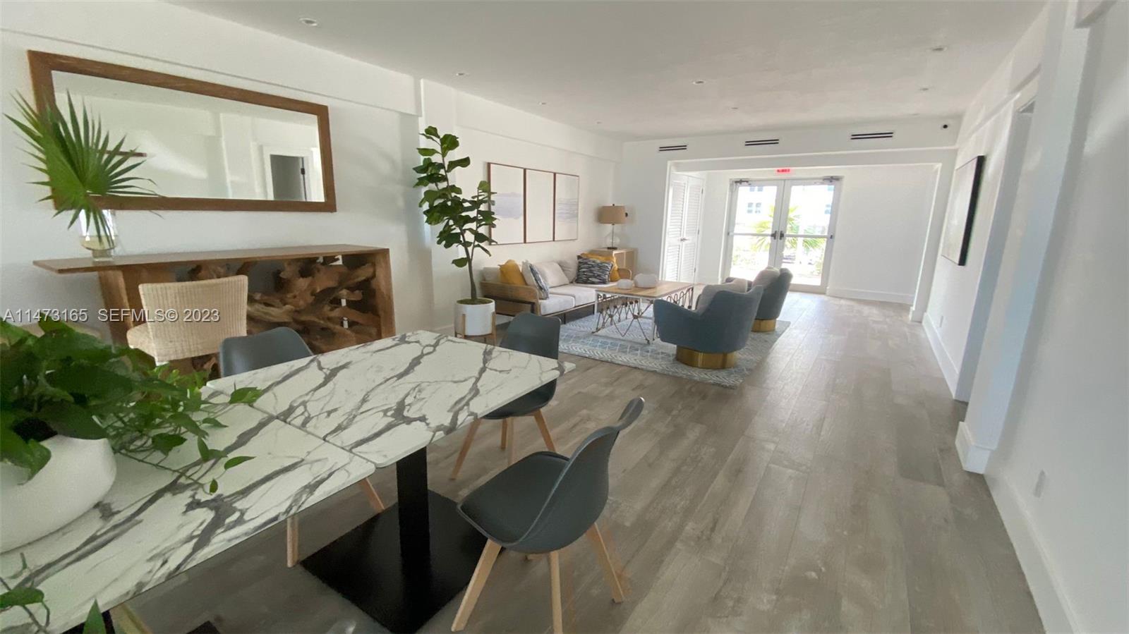 1801 South Surf Road, Unit 4C Hollywood, FL 33019 - Photo 13 of 14 a living room with furniture a fireplace and a potted plant