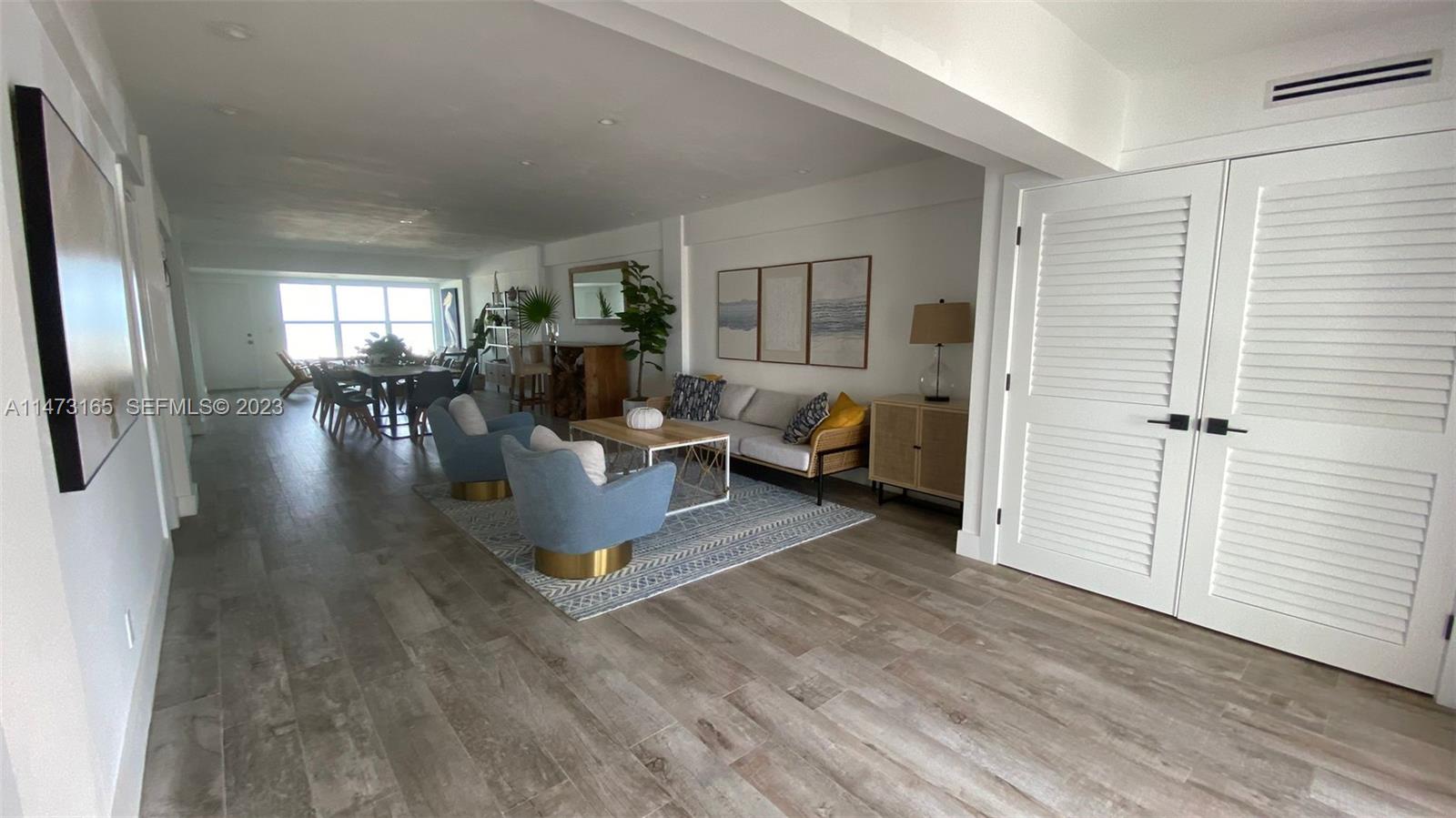 1801 South Surf Road, Unit 4C Hollywood, FL 33019 - Photo 10 of 14 a living room with furniture and a wooden floor