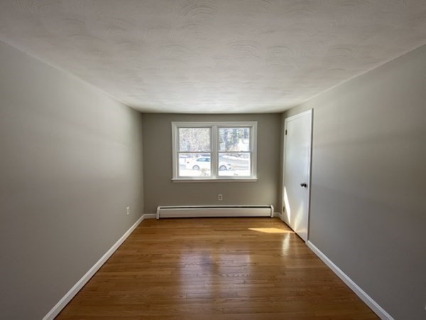 72 Bliss Street Northampton, MA 01062 - Photo 14 of 20 an empty room with wooden floor and windows