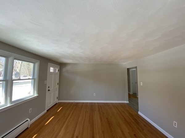 72 Bliss Street Northampton, MA 01062 - Photo 4 of 20 an empty room with wooden floor and windows