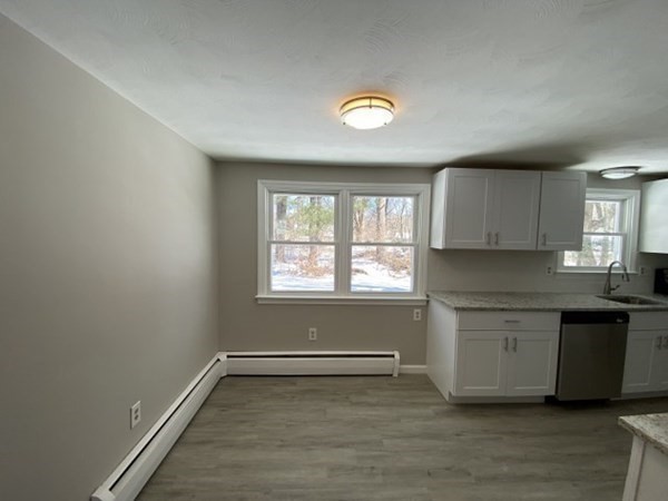 72 Bliss Street Northampton, MA 01062 - Photo 6 of 20 a view of a kitchen with a sink dishwasher and wooden floor
