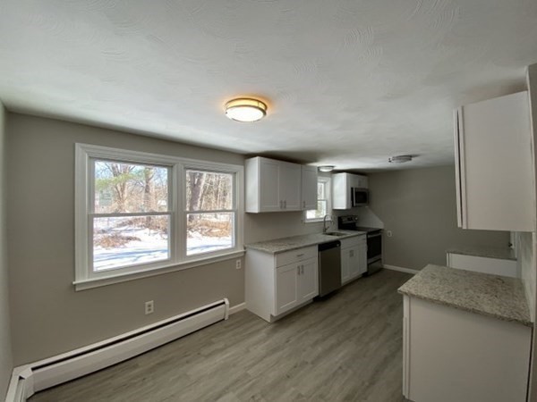 72 Bliss Street Northampton, MA 01062 - Photo 7 of 20 a kitchen with stainless steel appliances granite countertop a stove a sink and a large window