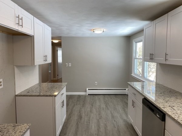 72 Bliss Street Northampton, MA 01062 - Photo 10 of 20 a view of a kitchen with a sink and dishwasher a stove top oven with wooden floor