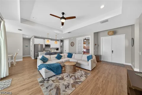 a living room with furniture and a wooden floor