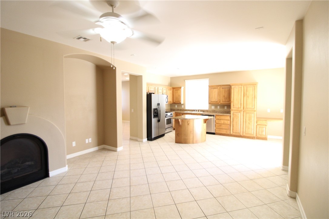 754 Rise Canyon Drive Henderson, NV 89052 - Photo 34 of 34 An open floorplan seamlessly connects the living area to a well-appointed kitchen, ideal for entertaining.