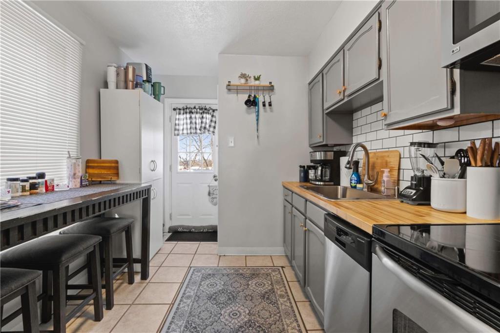 917 Session Street Pittsburgh, PA 15207 - Photo 7 of 15 a kitchen with stainless steel appliances granite countertop a sink stove and refrigerator