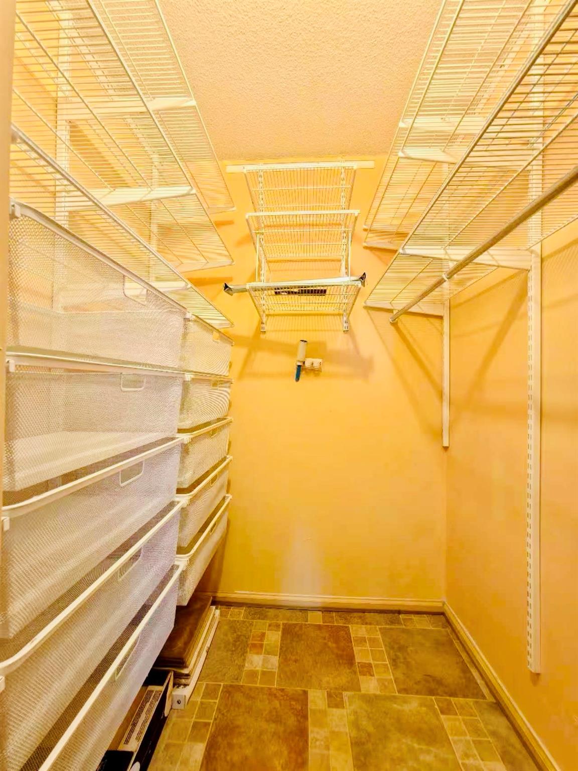 2 Bay Club Drive, Unit 16V Queens, NY 11360 - Photo 14 of 34 Walk in closet with stone finish flooring