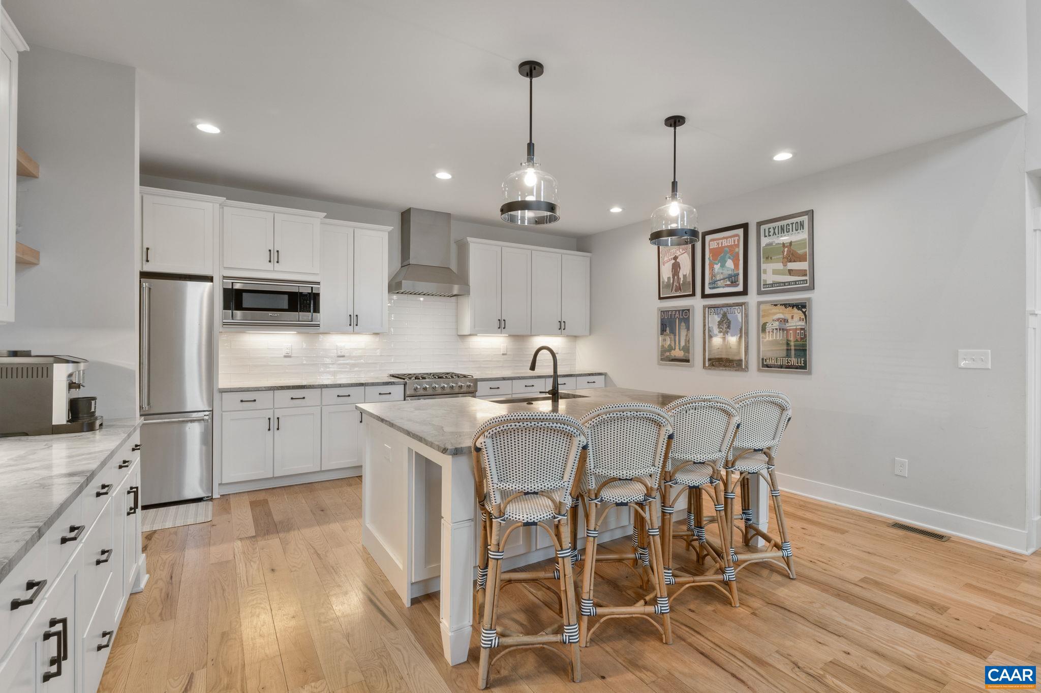 2206 Fowler Street Charlottesville, VA 22901 - Photo 11 of 59 a kitchen with stainless steel appliances granite countertop a dining table chairs stove refrigerator and cabinets