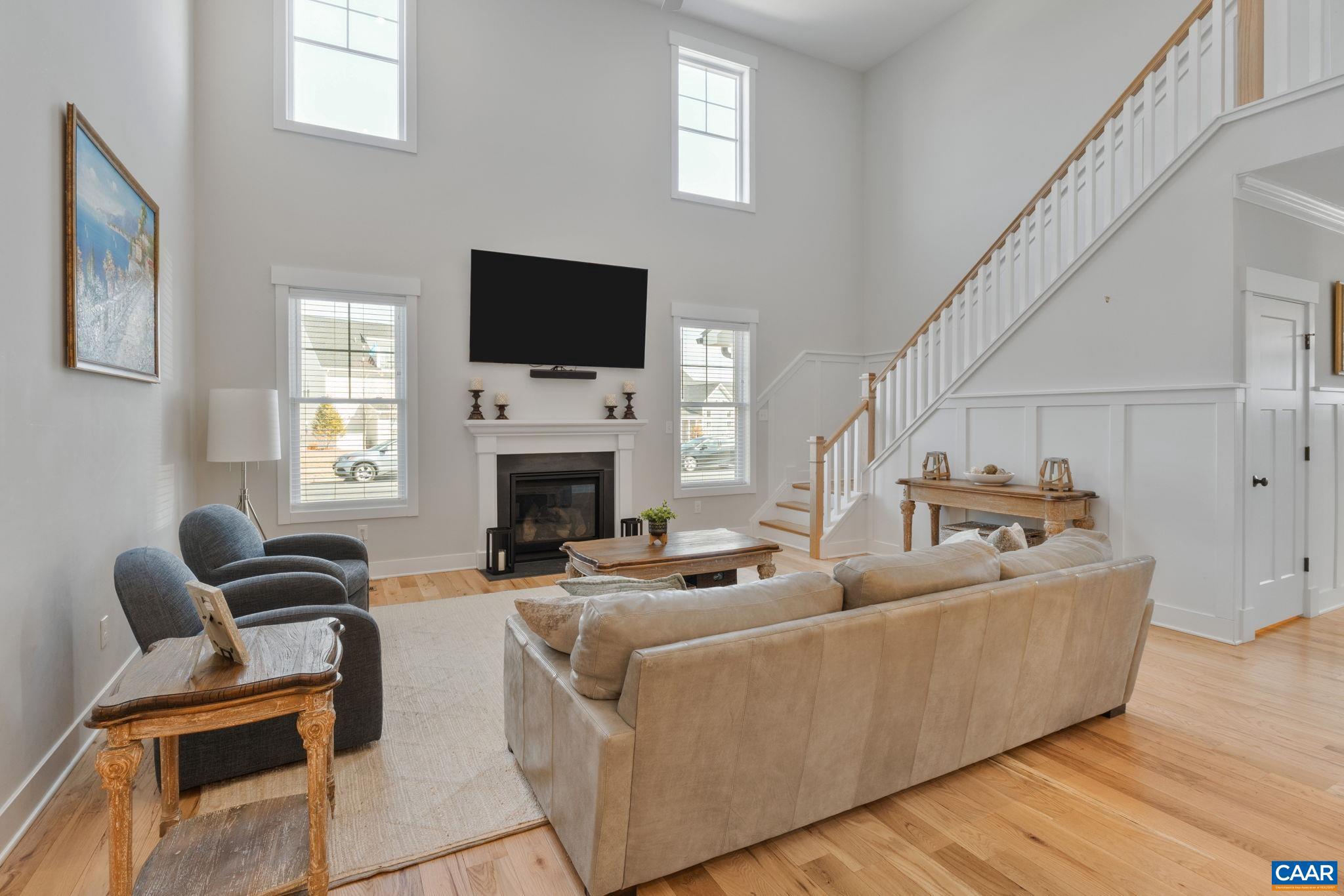 2206 Fowler Street Charlottesville, VA 22901 - Photo 16 of 59 a living room with furniture a flat screen tv and a fireplace