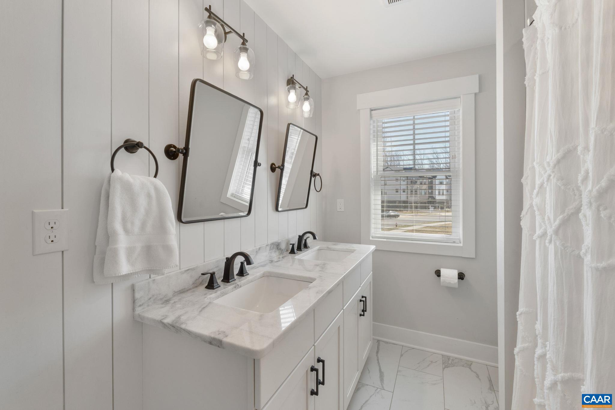 2206 Fowler Street Charlottesville, VA 22901 - Photo 29 of 59 a bathroom with 2 sink and a mirror