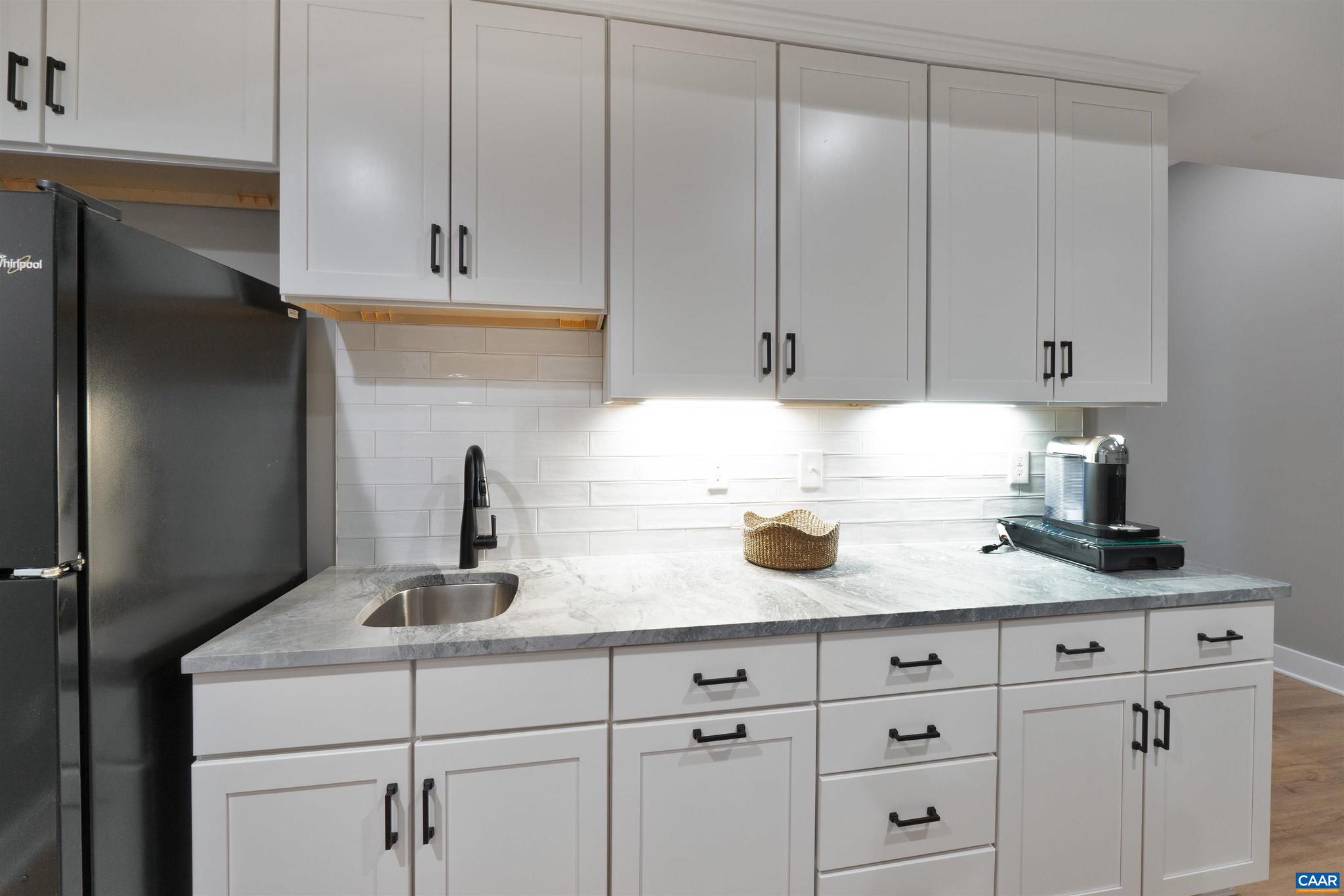 2206 Fowler Street Charlottesville, VA 22901 - Photo 39 of 59 a kitchen with granite countertop white cabinets and a sink
